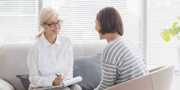 Smiling therapist with patient