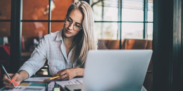 Young focused woman working with chart