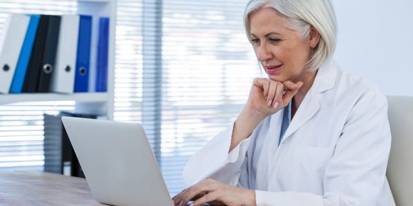 Thoughtful female doctor working on her laptop